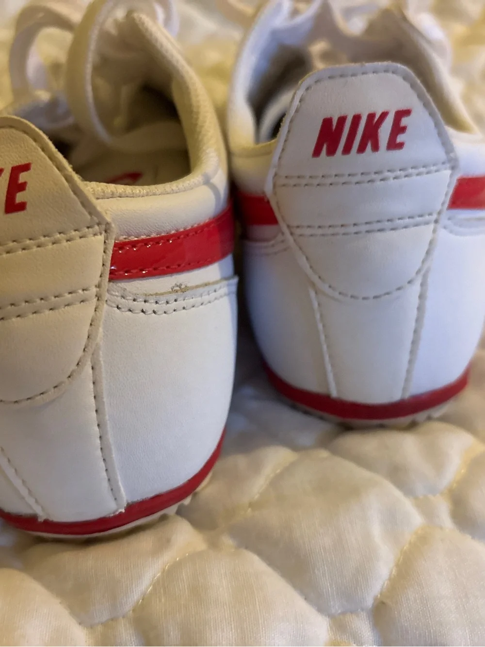 Nike White Sneakers with Pink Swoosh Accents